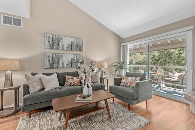 1682 Circa Del Lago Unit A306, San Marcos, CA 92078 - living room featuring light wood-style flooring and high vaulted ceiling