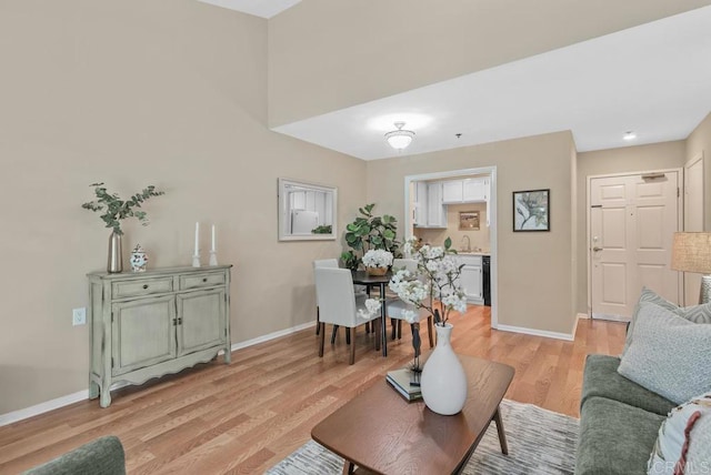 1682 Circa Del Lago Unit A306, San Marcos, CA 92078 - living area featuring baseboards and light wood-style floors