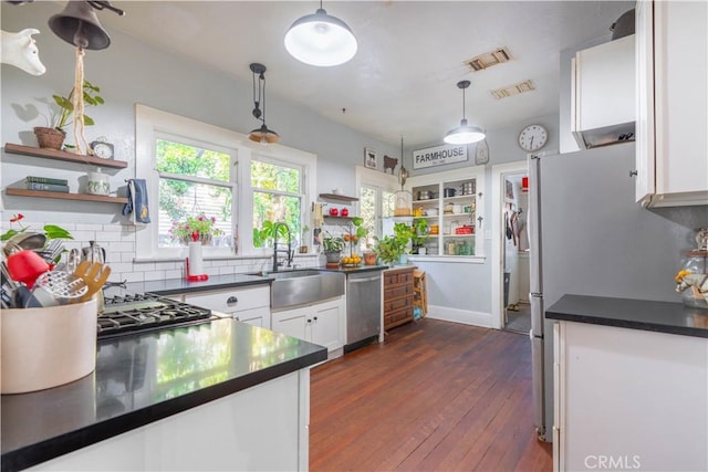 7914 Magnolia Ave, Riverside, CA 92504 - kitchen with open shelves, appliances with stainless steel finishes, dark countertops, and white cabinetry