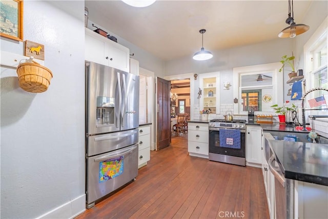 7914 Magnolia Ave, Riverside, CA 92504 - kitchen featuring stainless steel appliances, dark countertops, white cabinetry, dark wood-type flooring, and pendant lighting