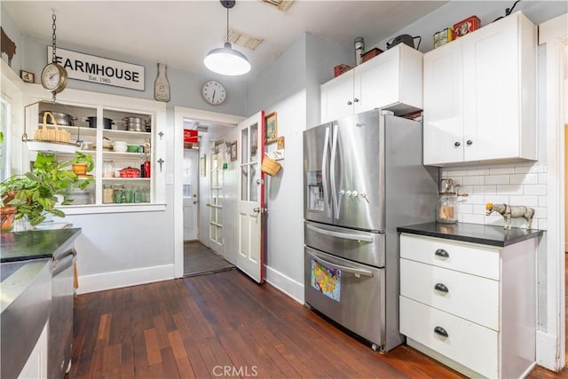 7914 Magnolia Ave, Riverside, CA 92504 - kitchen with stainless steel appliances, dark wood-style floors, dark countertops, decorative backsplash, and white cabinets