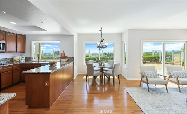 2245 Avenida Oliva, San Clemente, CA 92673 - kitchen featuring light stone countertops, a peninsula, healthy amount of natural light, hanging light fixtures, and recessed lighting