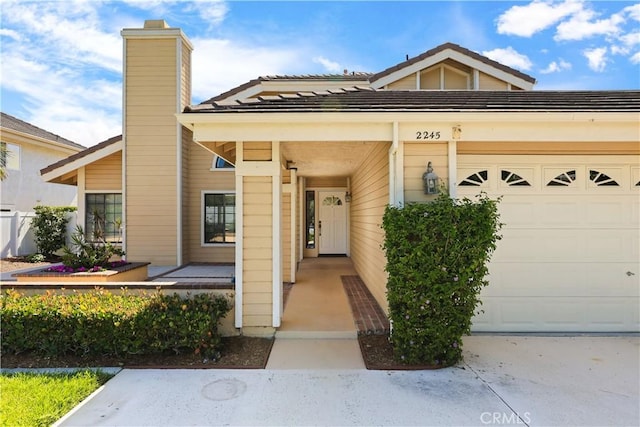 2245 Avenida Oliva, San Clemente, CA 92673 - view of exterior entry featuring a chimney and a garage