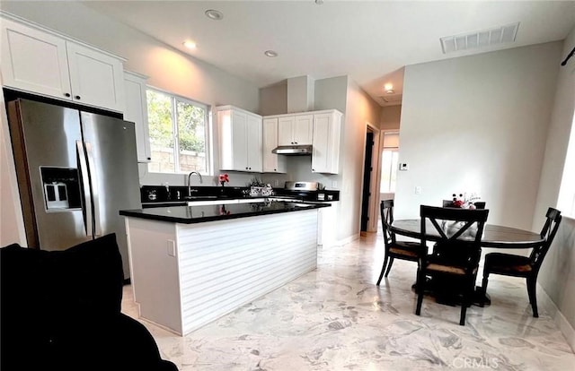 1204 Arbenz Cir, Corona, CA 92881 - kitchen with stainless steel appliances, light marble finish flooring, under cabinet range hood, white cabinetry, and dark countertops