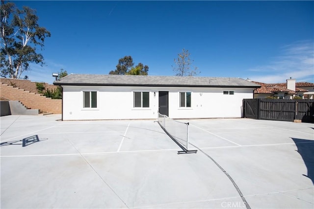 1204 Arbenz Cir, Corona, CA 92881 - rear view of house featuring stucco siding and a tennis court
