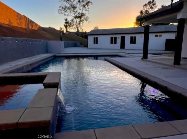 1204 Arbenz Cir, Corona, CA 92881 - pool at dusk with a patio, a fenced backyard, and a pool with connected hot tub