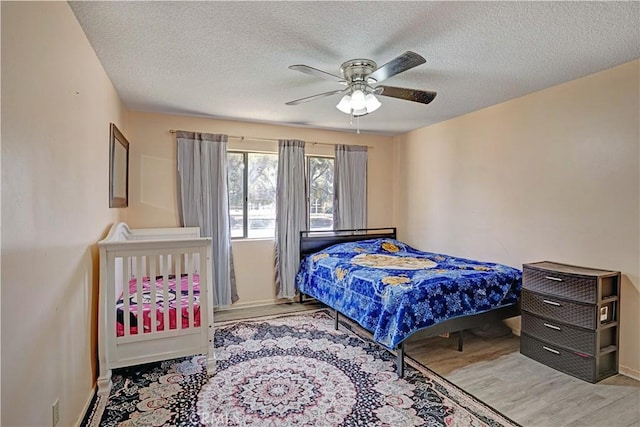 260 E Whittier Ave, Hemet, CA 92543 - bedroom with wood finished floors, a textured ceiling, and a ceiling fan