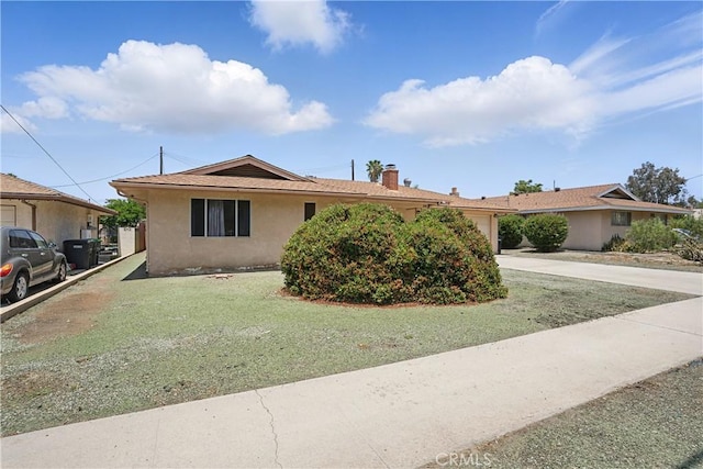 260 E Whittier Ave, Hemet, CA 92543 - ranch-style house featuring stucco siding, an attached garage, a chimney, concrete driveway, and a front yard