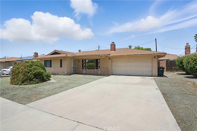 260 E Whittier Ave, Hemet, CA 92543 - ranch-style home with an attached garage, stucco siding, concrete driveway, and a chimney