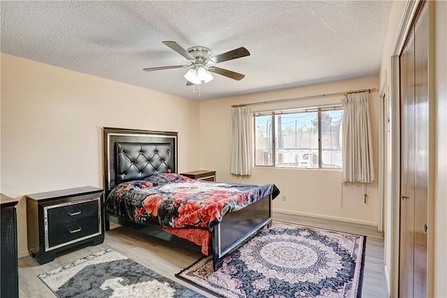 260 E Whittier Ave, Hemet, CA 92543 - bedroom with light wood-style flooring, a textured ceiling, and a ceiling fan