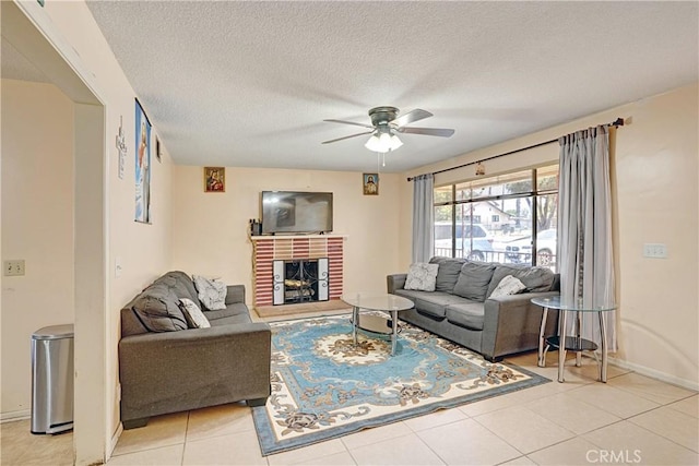 260 E Whittier Ave, Hemet, CA 92543 - living area with a ceiling fan, light tile patterned floors, a fireplace, and a textured ceiling
