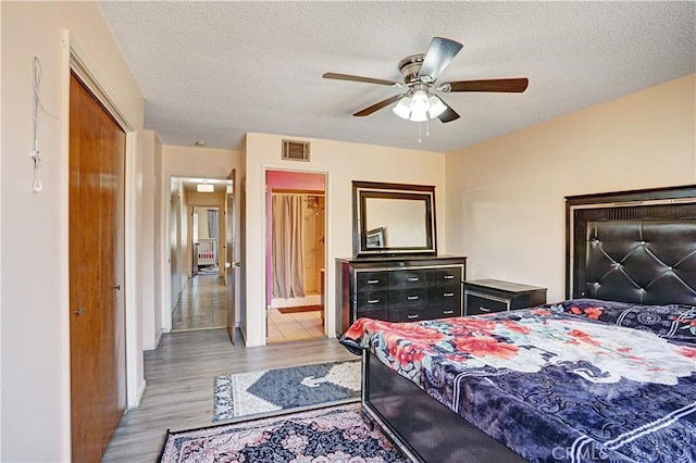 260 E Whittier Ave, Hemet, CA 92543 - bedroom featuring light wood-type flooring, a textured ceiling, ceiling fan, and ensuite bathroom