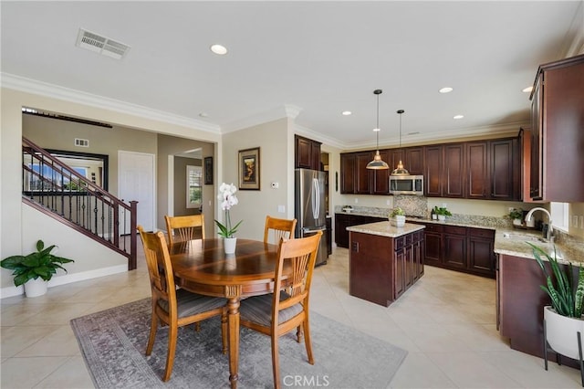 33976 Galleron St, Temecula, CA 92592 - dining area with light tile patterned floors, recessed lighting, crown molding, and stairs