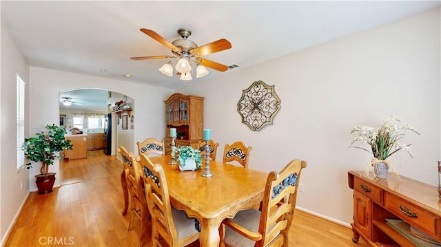 7075 Montana Ave, Fontana, CA 92336 - dining space with ceiling fan, light wood-style flooring, and arched walkways