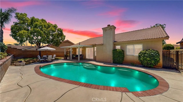 7075 Montana Ave, Fontana, CA 92336 - pool at dusk with a patio area and a fenced backyard