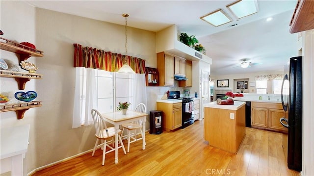 7075 Montana Ave, Fontana, CA 92336 - kitchen featuring black appliances, light wood finished floors, a kitchen island, range hood, and light countertops