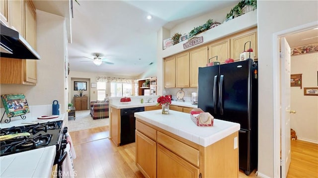 7075 Montana Ave, Fontana, CA 92336 - kitchen with black appliances, under cabinet range hood, light brown cabinets, light wood-type flooring, and recessed lighting