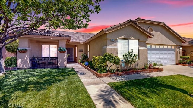 7075 Montana Ave, Fontana, CA 92336 - view of front facade with a front yard, an attached garage, concrete driveway, a tiled roof, and stucco siding