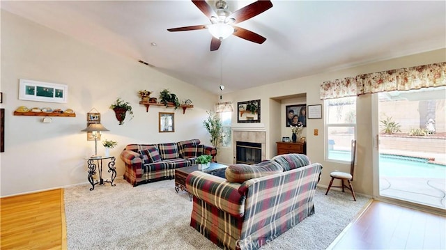 7075 Montana Ave, Fontana, CA 92336 - living area with a tile fireplace, a ceiling fan, wood finished floors, and vaulted ceiling