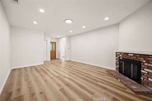 181 W Casad St, Covina, CA 91723 - unfurnished living room with light wood-type flooring, recessed lighting, and a brick fireplace
