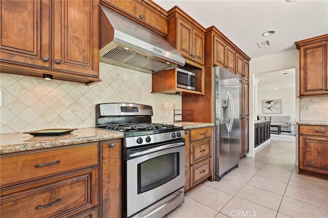 20681 Via Amarilla, Yorba Linda, CA 92886 - kitchen featuring stainless steel appliances, under cabinet range hood, backsplash, brown cabinetry, and light tile patterned floors