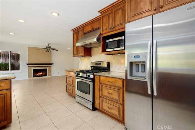 20681 Via Amarilla, Yorba Linda, CA 92886 - kitchen with stainless steel appliances, extractor fan, ceiling fan, tasteful backsplash, and brown cabinets