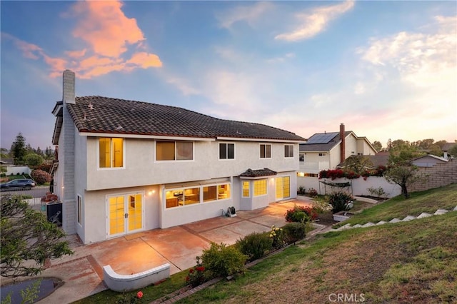 20681 Via Amarilla, Yorba Linda, CA 92886 - back of house at dusk featuring a patio area, stucco siding, and a tile roof