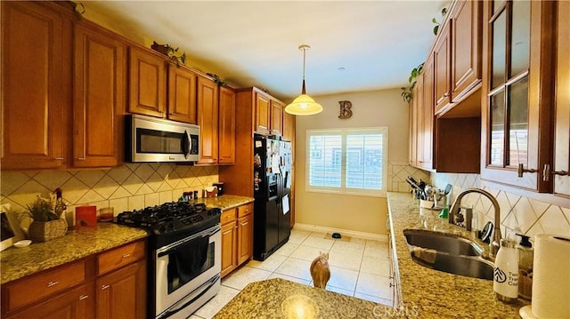 5241 Colodny Dr Unit 403, Agoura Hills, CA 91301 - kitchen with stainless steel appliances, decorative backsplash, and light stone counters