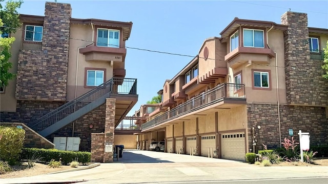 5241 Colodny Dr Unit 403, Agoura Hills, CA 91301 - view of building exterior with an attached garage and driveway