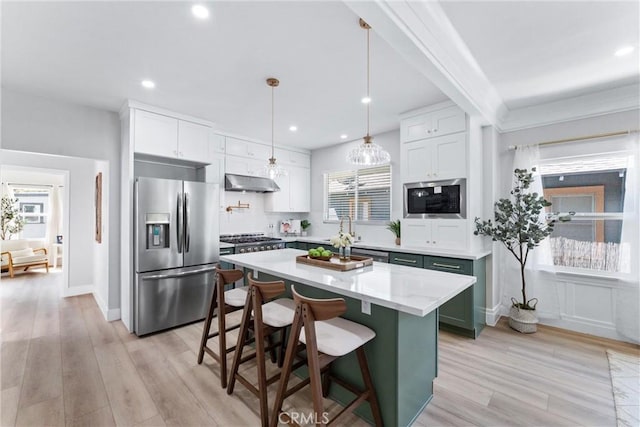 4400 Homer St, Los Angeles, CA 90031 - kitchen featuring appliances with stainless steel finishes, under cabinet range hood, light wood-type flooring, recessed lighting, and a kitchen island