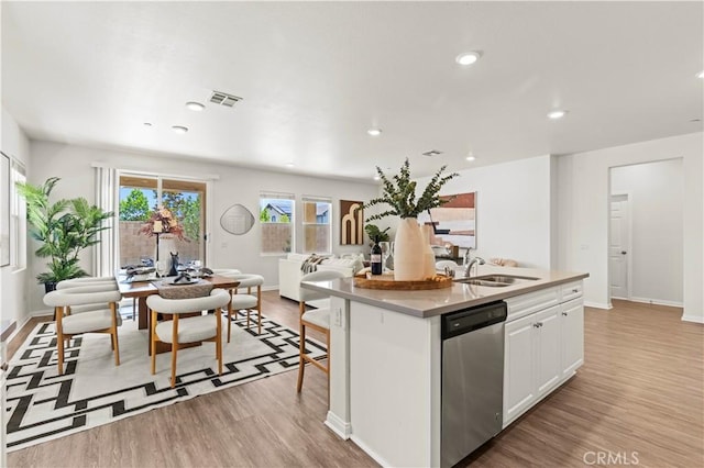4733 S Rogers Way, Ontario, CA 91762 - kitchen with stainless steel dishwasher, light wood-type flooring, white cabinets, an island with sink, and recessed lighting