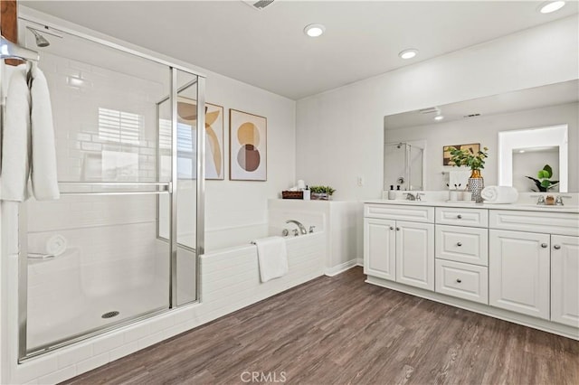 4733 S Rogers Way, Ontario, CA 91762 - full bathroom featuring a stall shower, double vanity, a bath, wood finished floors, and recessed lighting