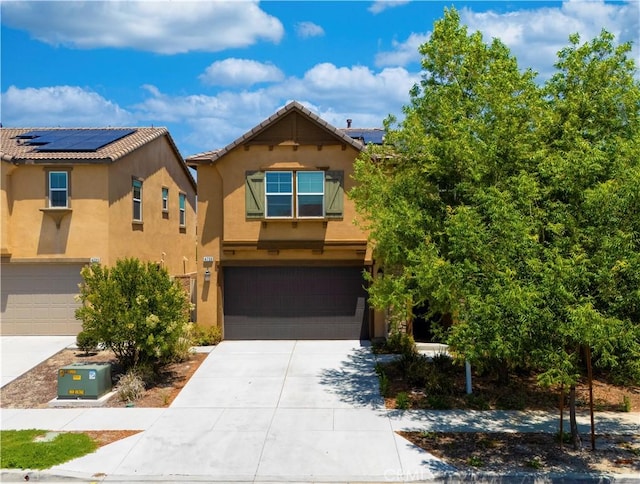 4733 S Rogers Way, Ontario, CA 91762 - view of front of home with stucco siding, driveway, roof mounted solar panels, a garage, and a tile roof