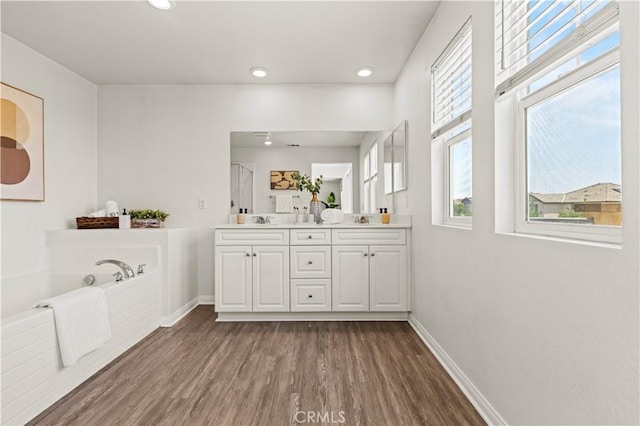 4733 S Rogers Way, Ontario, CA 91762 - bathroom featuring double vanity, wood finished floors, a bath, recessed lighting, and a shower