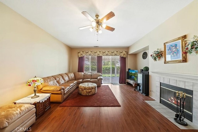 12744 Palmetto Ct, Riverside, CA 92503 - living area featuring a ceiling fan, a tiled fireplace, and wood finished floors