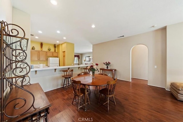 12744 Palmetto Ct, Riverside, CA 92503 - dining room with wood finished floors, arched walkways, and recessed lighting
