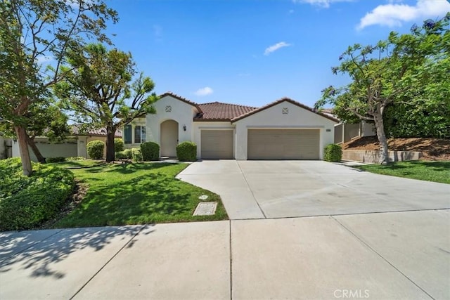 12744 Palmetto Ct, Riverside, CA 92503 - mediterranean / spanish-style home with a garage, stucco siding, concrete driveway, a tile roof, and a front yard