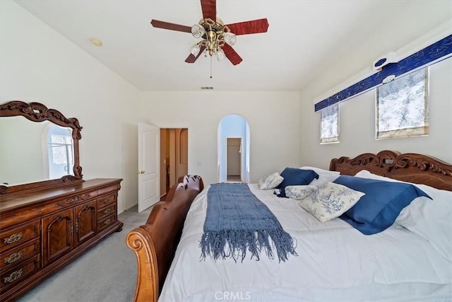 12744 Palmetto Ct, Riverside, CA 92503 - bedroom featuring light colored carpet, a ceiling fan, and arched walkways