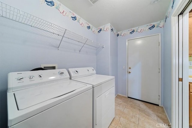 12744 Palmetto Ct, Riverside, CA 92503 - washroom with washer and dryer and light tile patterned flooring