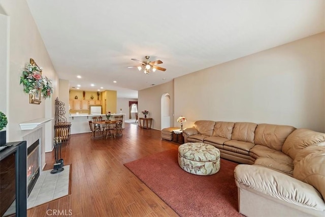 12744 Palmetto Ct, Riverside, CA 92503 - living room with ceiling fan, wood finished floors, arched walkways, recessed lighting, and a fireplace