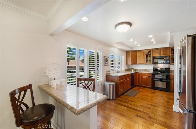 5185 Duenas, Laguna Woods, CA 92637 - kitchen featuring range, black microwave, freestanding refrigerator, a peninsula, and ornamental molding
