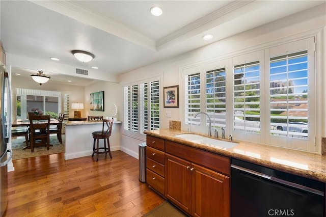 5185 Duenas, Laguna Woods, CA 92637 - kitchen featuring black dishwasher, brown cabinetry, hardwood / wood-style floors, recessed lighting, and crown molding