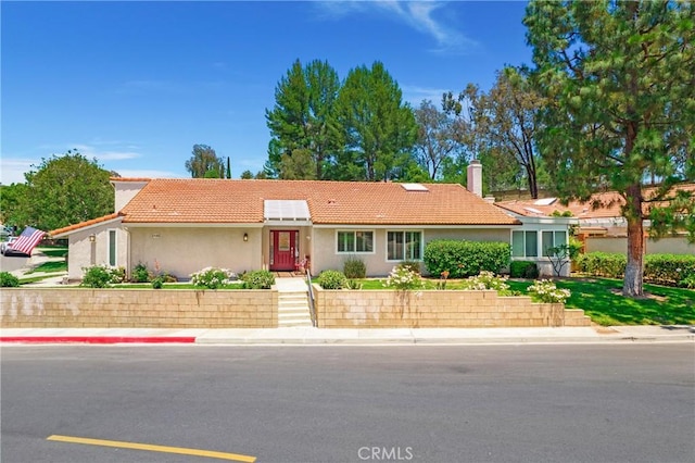 5185 Duenas, Laguna Woods, CA 92637 - ranch-style house with a tile roof, a chimney, and stucco siding