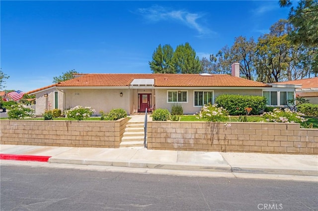 5185 Duenas, Laguna Woods, CA 92637 - ranch-style house with a tile roof, a chimney, and stucco siding