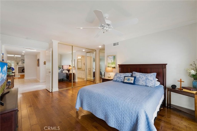 5185 Duenas, Laguna Woods, CA 92637 - bedroom with wood finished floors, ornamental molding, a ceiling fan, and ensuite bath