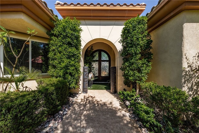 56102 Baltusrol Ln, Quinta, CA 92253 - property entrance with stucco siding, french doors, and a tiled roof