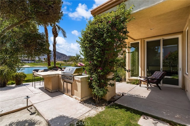 56102 Baltusrol Ln, Quinta, CA 92253 - view of patio featuring area for grilling and a water and mountain view