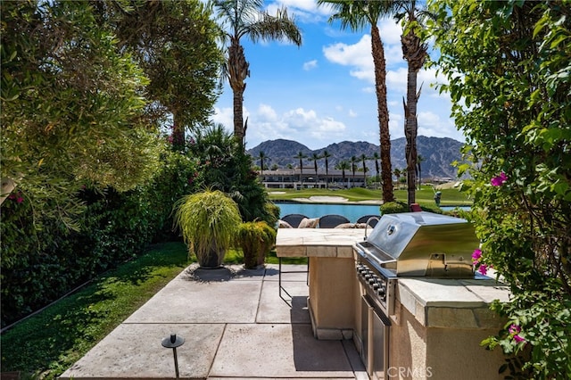 56102 Baltusrol Ln, Quinta, CA 92253 - view of patio / terrace with exterior kitchen and a water and mountain view