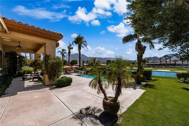 56102 Baltusrol Ln, Quinta, CA 92253 - outdoor pool with ceiling fan, a patio area, a yard, and a water and mountain view