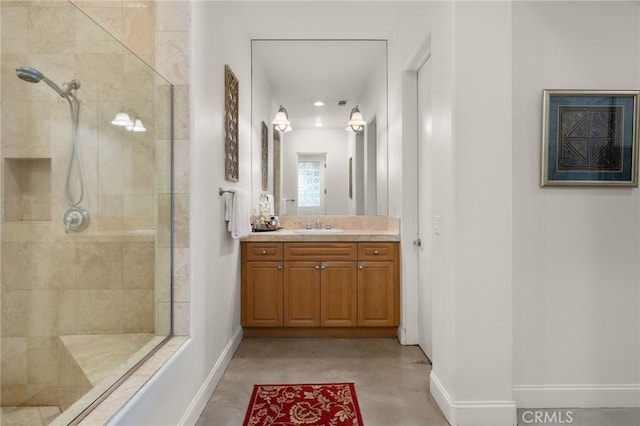 56102 Baltusrol Ln, Quinta, CA 92253 - bathroom with a tile shower, vanity, and concrete floors